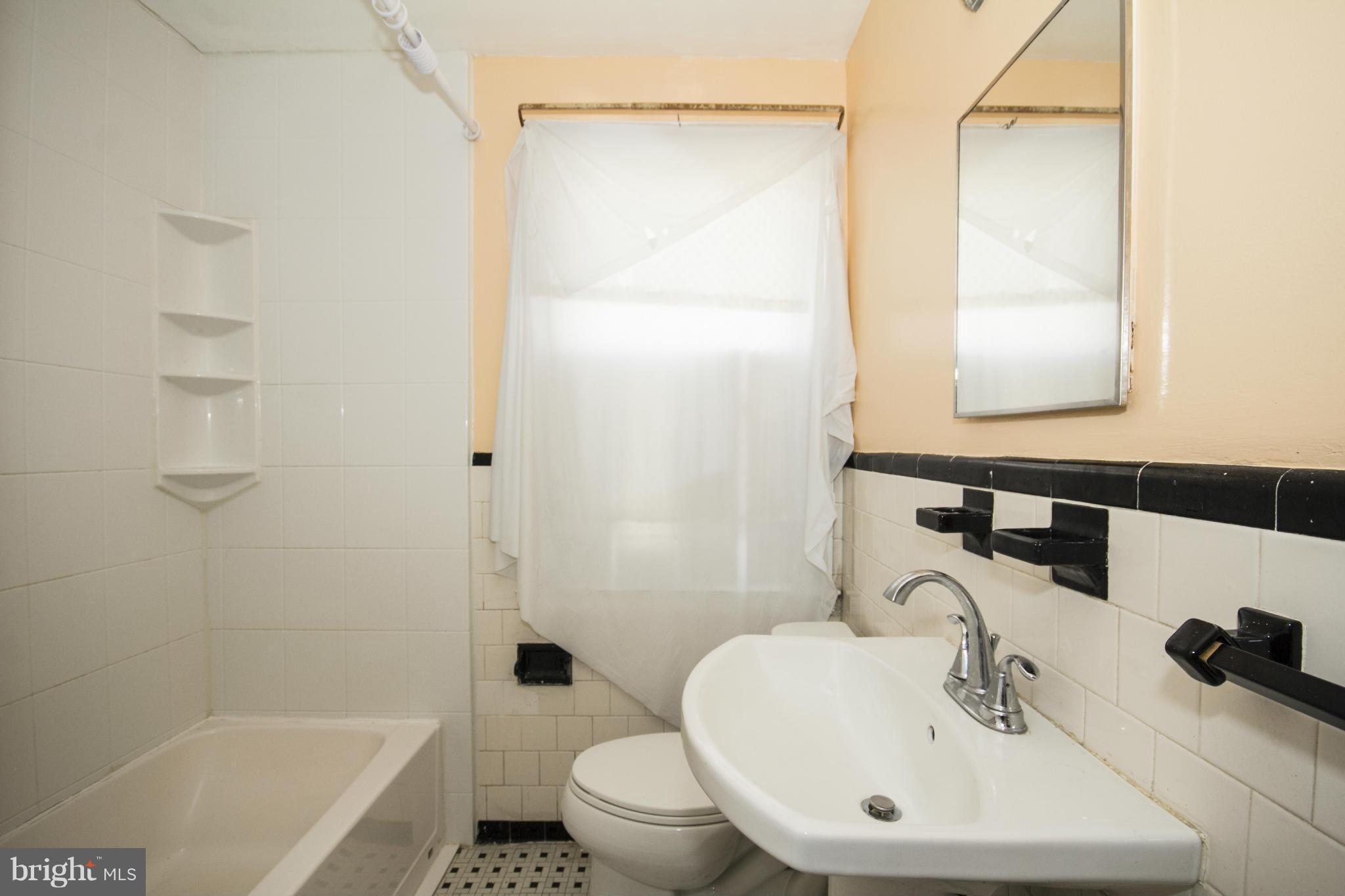 1673 Northbourne Road Baltimore, MD 21239 - Photo 18 of 21 a bathroom with a sink a toilet and shower