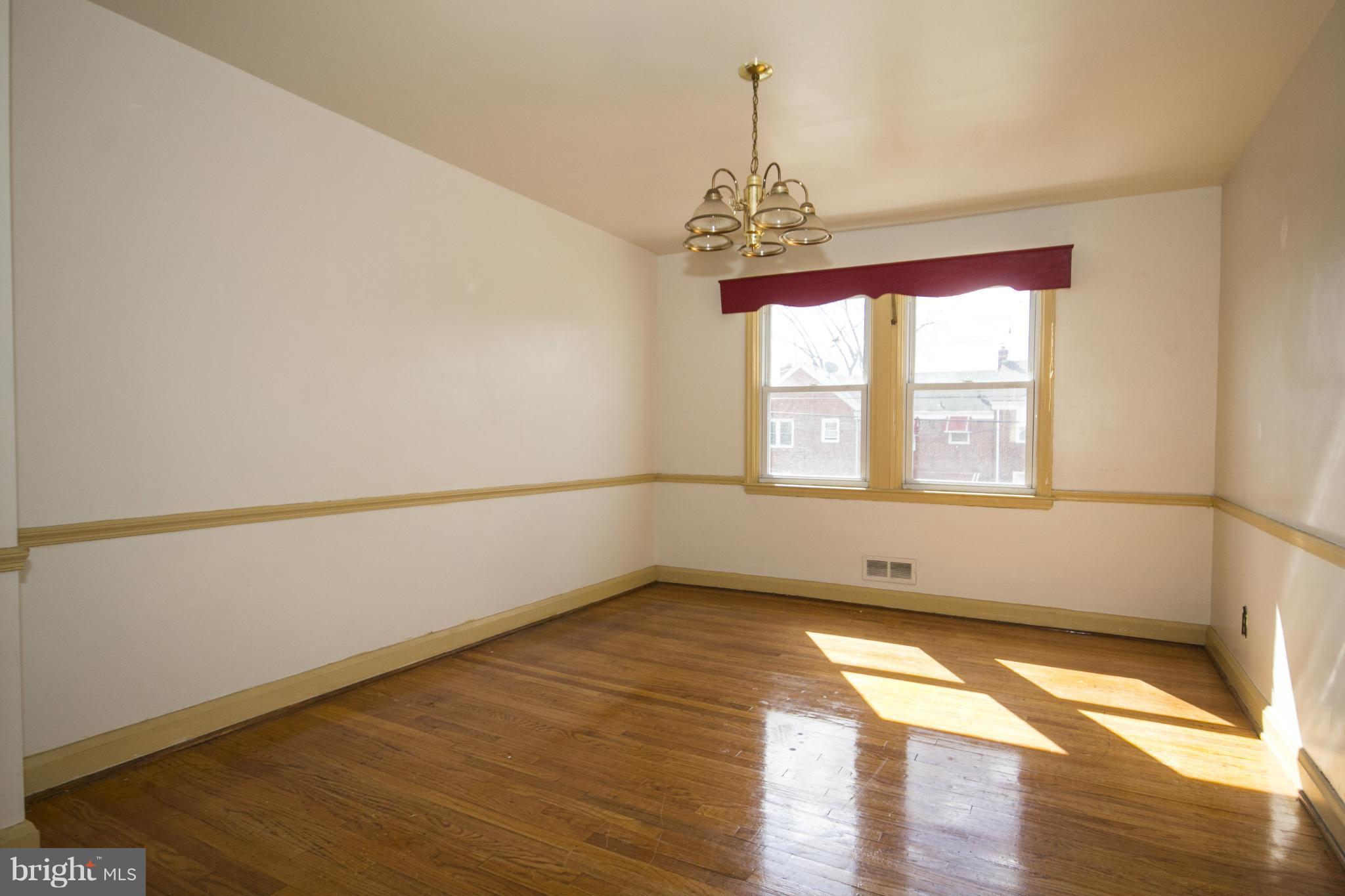 1673 Northbourne Road Baltimore, MD 21239 - Photo 6 of 21 a view of empty room with wooden floor and fan