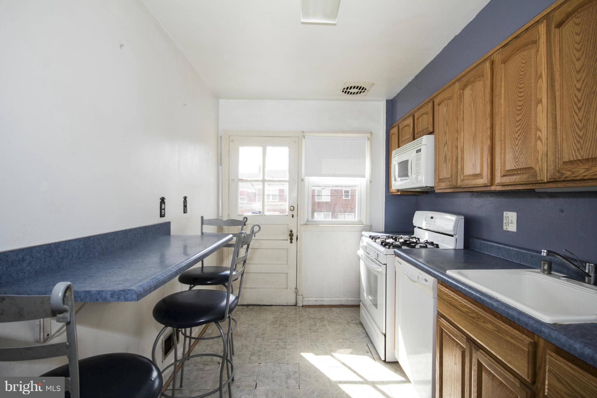 1673 Northbourne Road Baltimore, MD 21239 - Photo 8 of 21 a kitchen with a sink a stove and cabinets