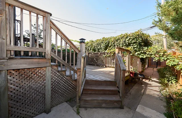 a view of a porch with wooden floor and bench