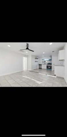a view of a kitchen with kitchen island sink stainless steel appliances