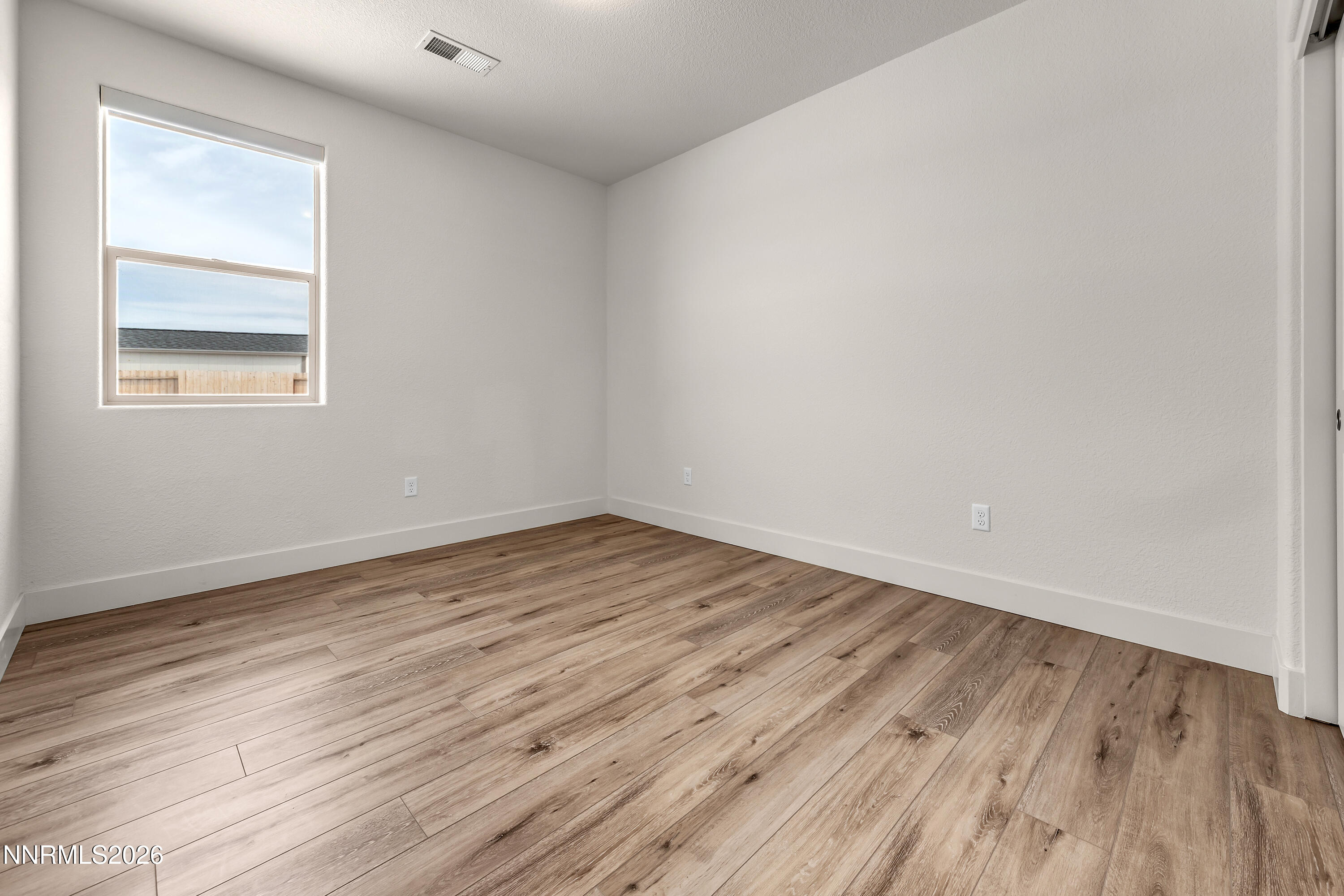 815 North Thunder Butte Court Reno, NV 89506 - Photo 22 of 35 an empty room with wooden floor and windows