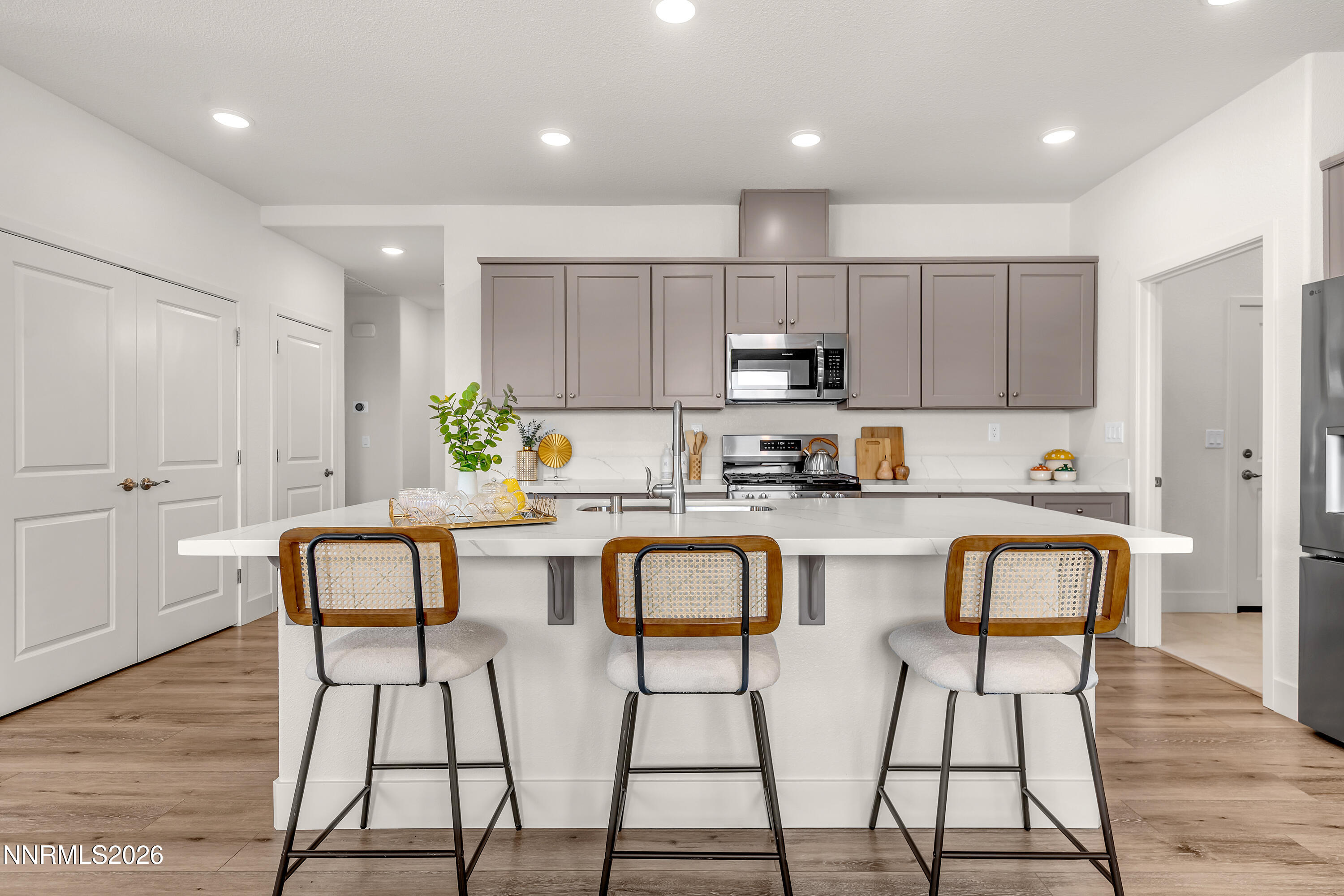 815 North Thunder Butte Court Reno, NV 89506 - Photo 7 of 35 a kitchen with stainless steel appliances granite countertop a table chairs sink and cabinets