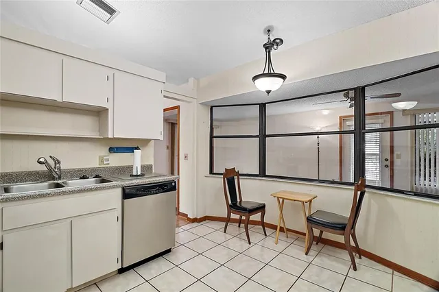 a kitchen with a sink cabinets and window
