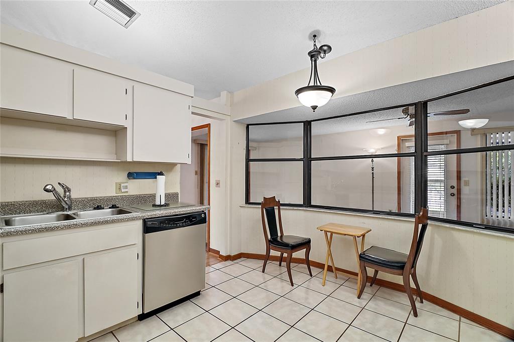 501 Cherry Tree Street Eustis, FL 32726 - Photo 12 of 35 a kitchen with a sink cabinets and window