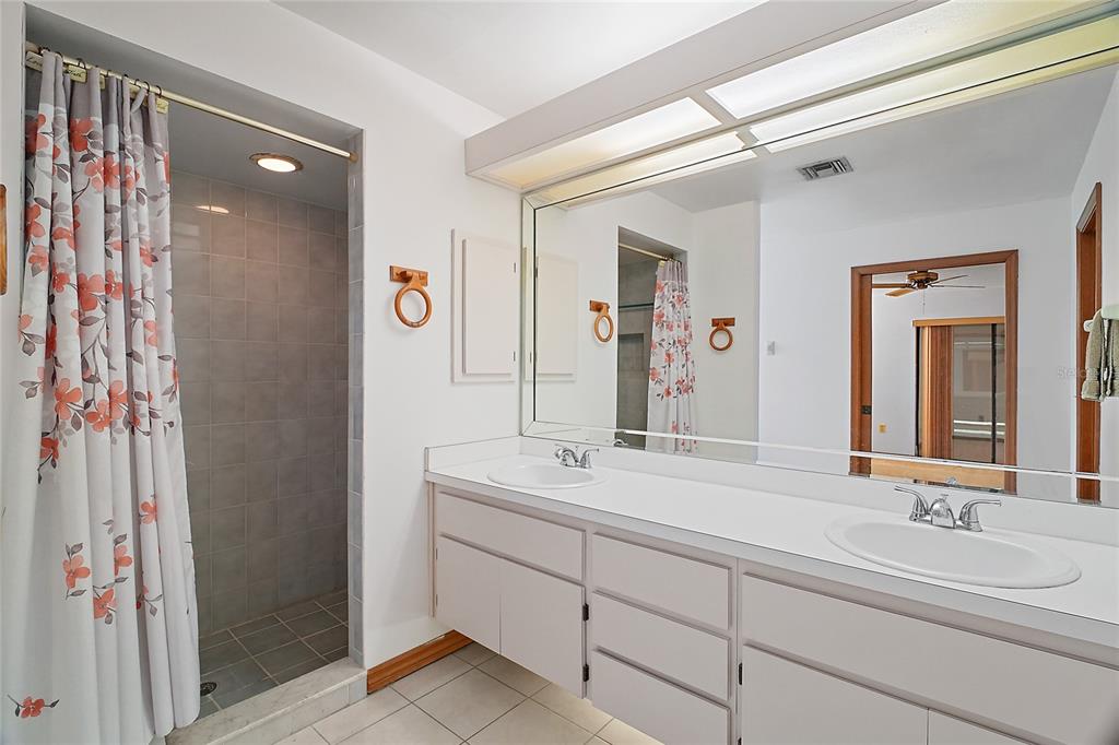 501 Cherry Tree Street Eustis, FL 32726 - Photo 19 of 35 a bathroom with a double vanity sink mirror and double