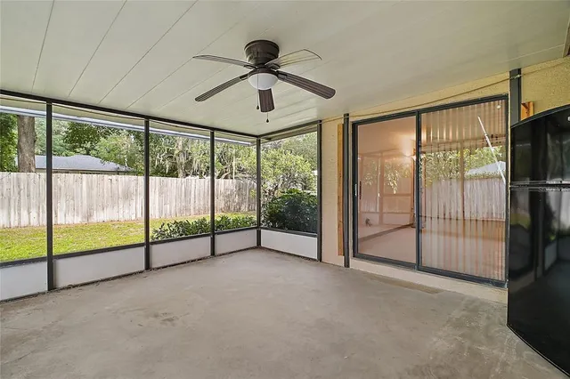 a view of an empty room with sliding windows