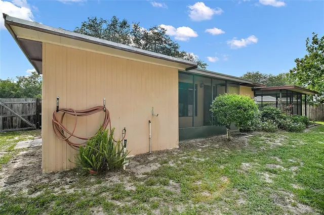 a view of house with backyard space and garden