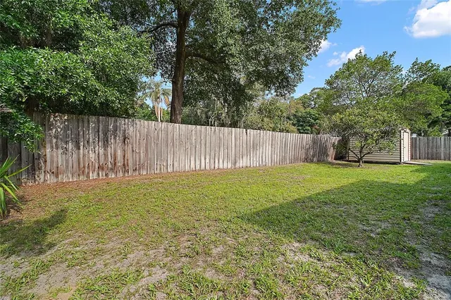 a view of wooden house with a yard