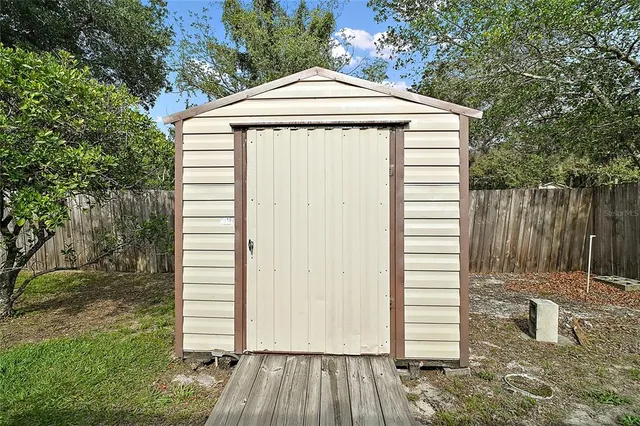 an aerial view of a house with a yard and trees
