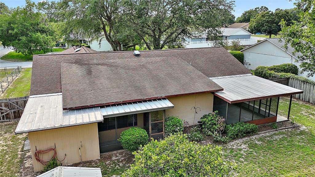 501 Cherry Tree Street Eustis, FL 32726 - Photo 31 of 35 an aerial view of a house with a yard and trees