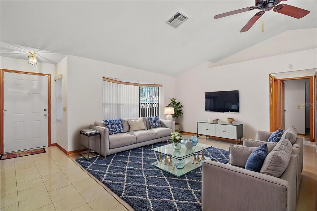 501 Cherry Tree Street Eustis, FL 32726 - Photo 4 of 35 a living room with furniture and a flat screen tv