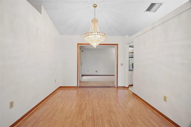 a view of a room with wooden floor white walls and stairs