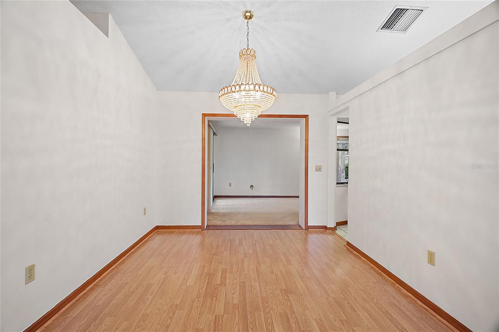 501 Cherry Tree Street Eustis, FL 32726 - Photo 6 of 35 a view of a room with wooden floor white walls and stairs