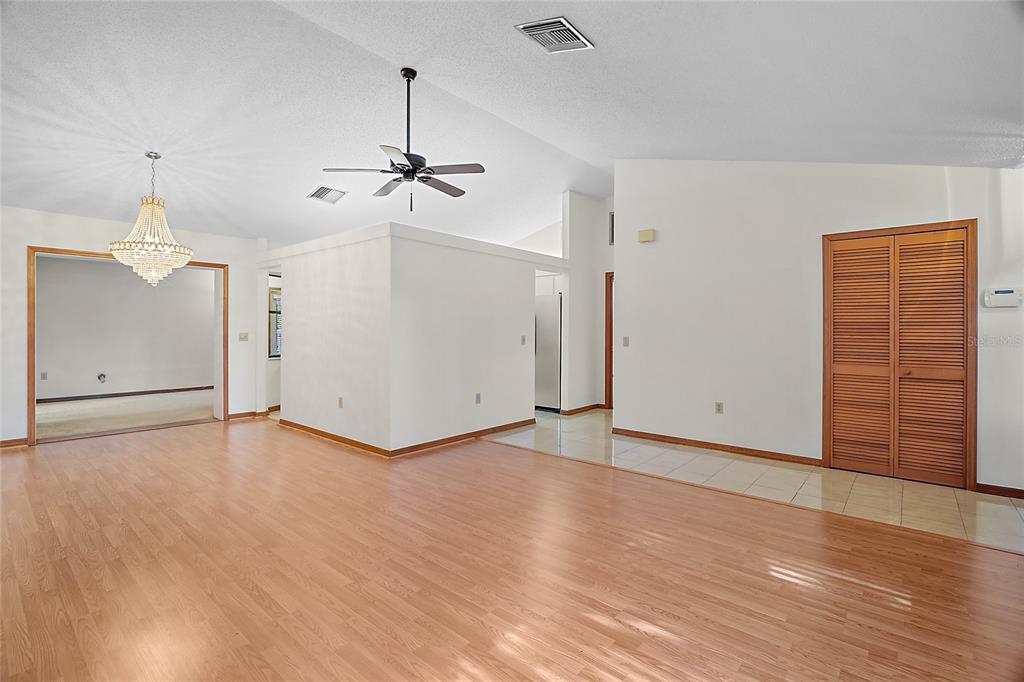 501 Cherry Tree Street Eustis, FL 32726 - Photo 8 of 35 wooden floor in an empty room with a window
