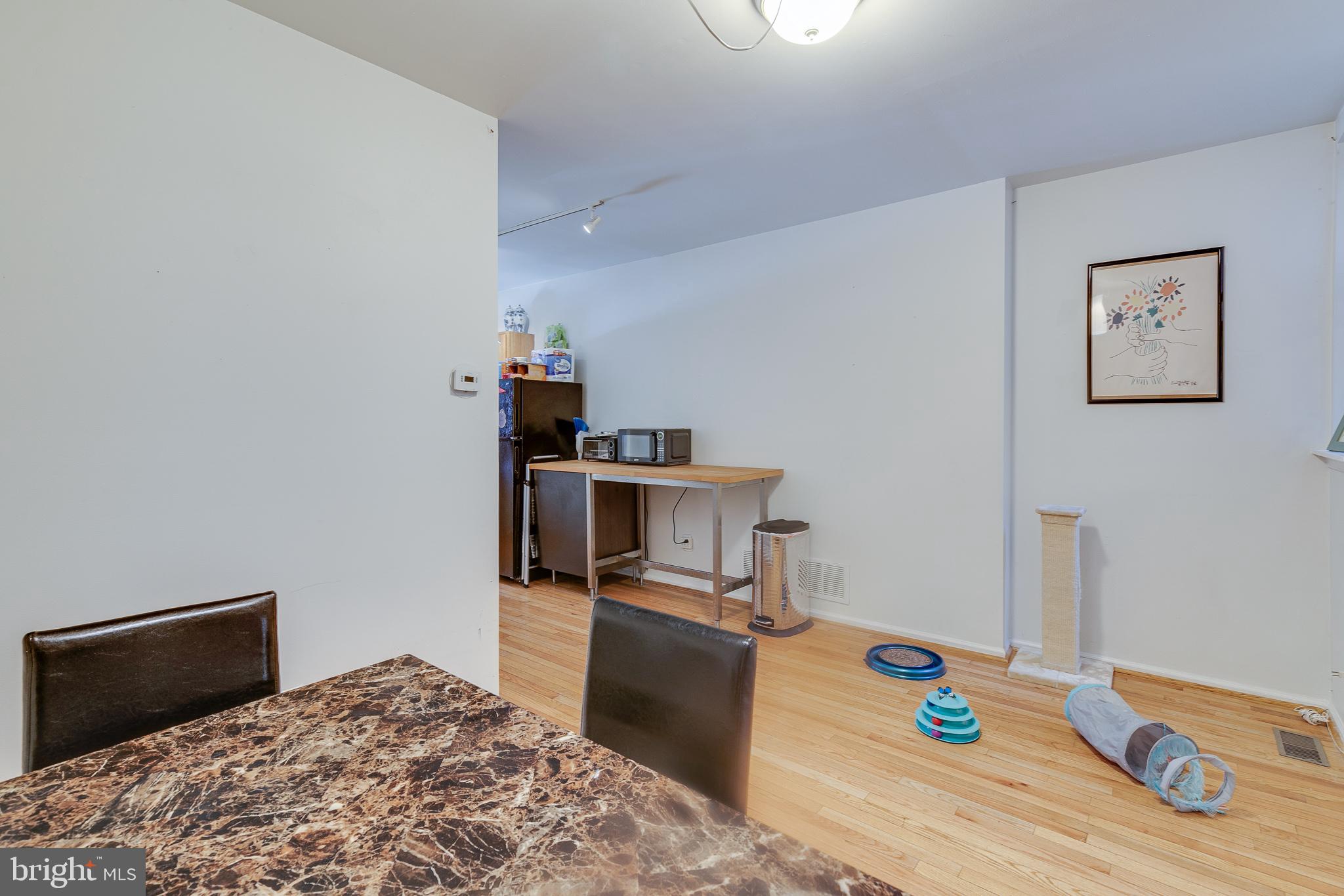 1004 Christian Street Philadelphia, PA 19147 - Photo 12 of 34 a bedroom with a bed and wooden floor