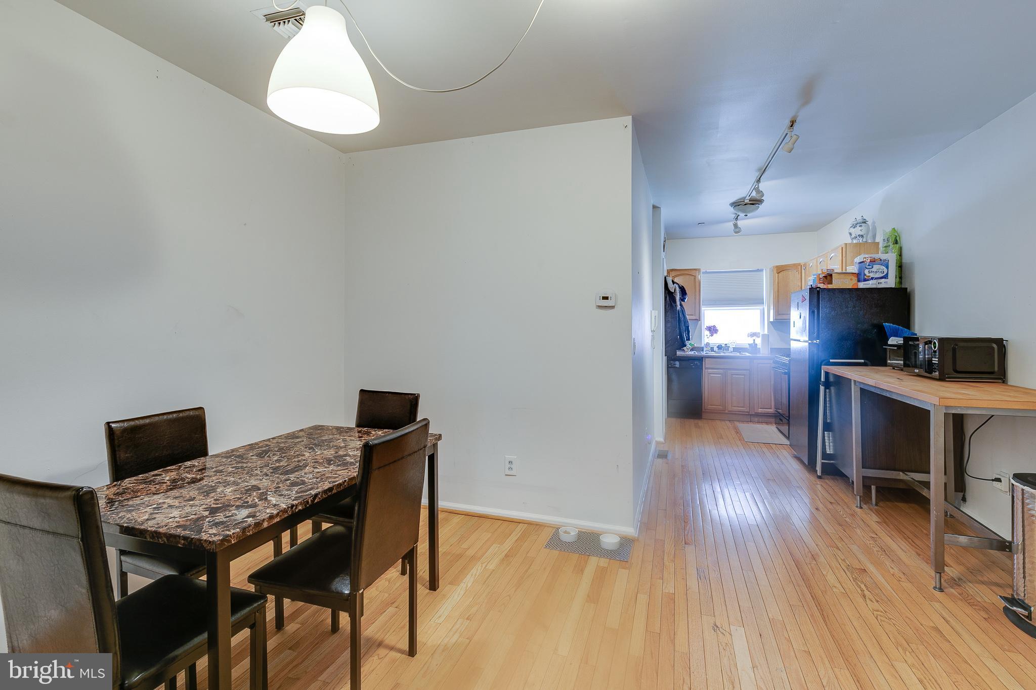 1004 Christian Street Philadelphia, PA 19147 - Photo 13 of 34 a kitchen with a table and chairs in it