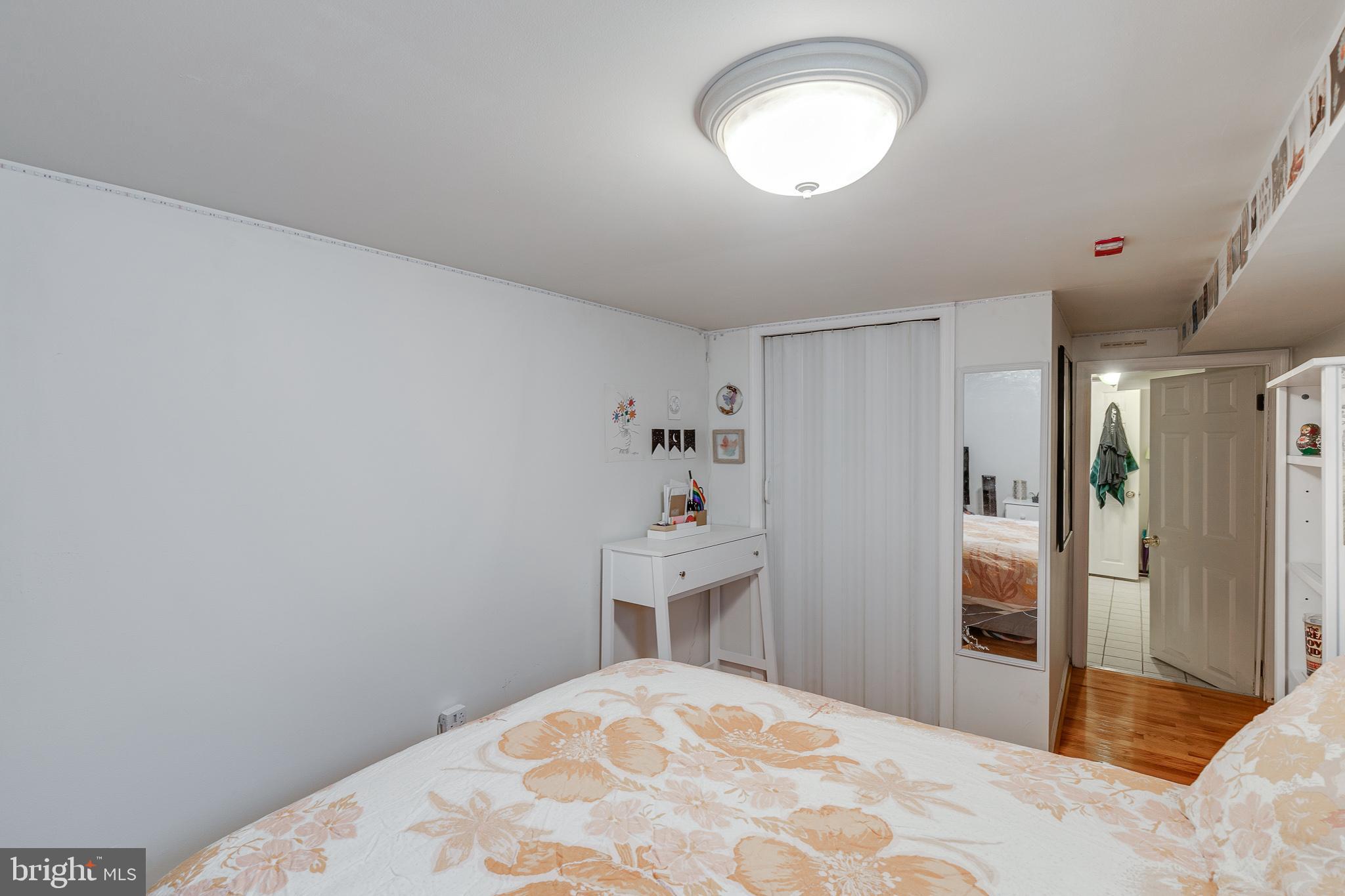 1004 Christian Street Philadelphia, PA 19147 - Photo 19 of 34 a bedroom with a bed and a chandelier