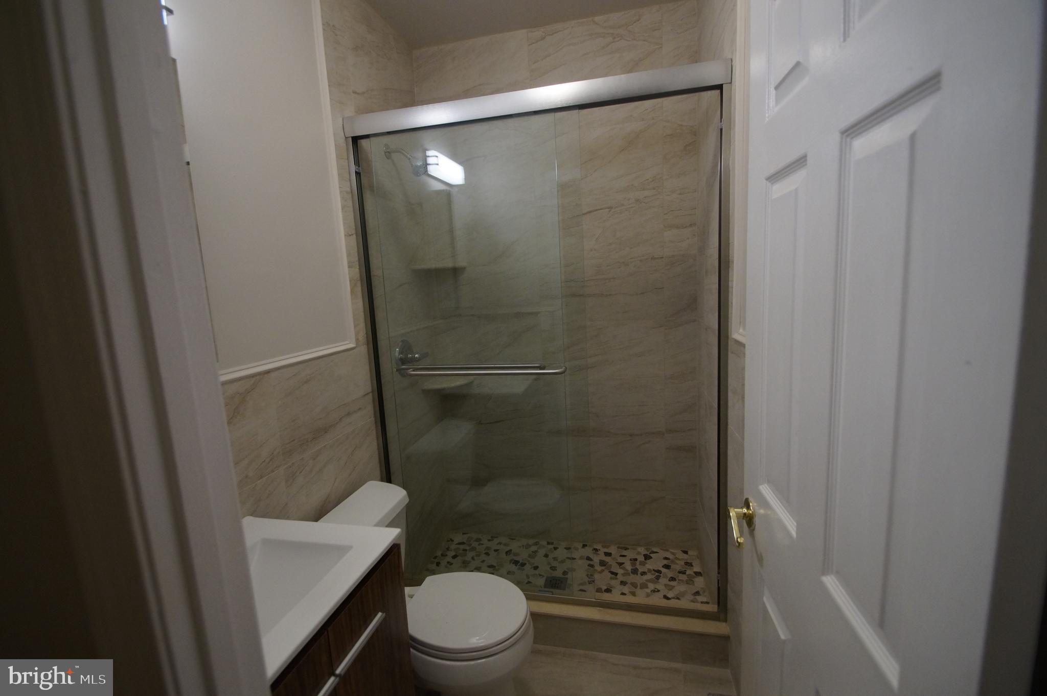 1004 Christian Street Philadelphia, PA 19147 - Photo 22 of 34 a bathroom with a shower a toilet and a sink