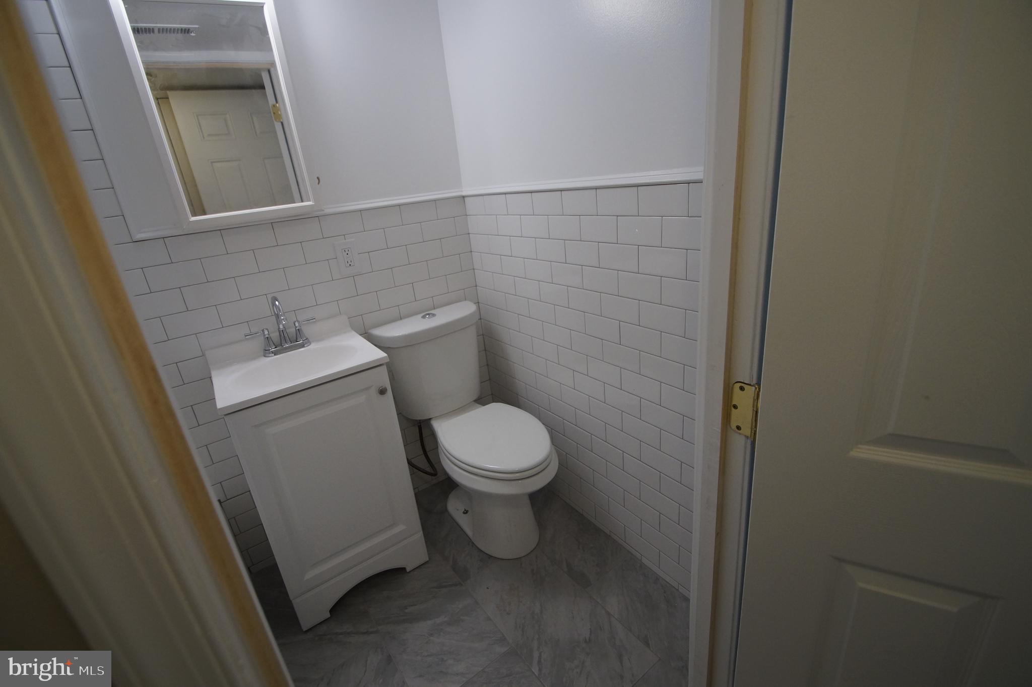 1004 Christian Street Philadelphia, PA 19147 - Photo 23 of 34 a white toilet sitting next to a small sink