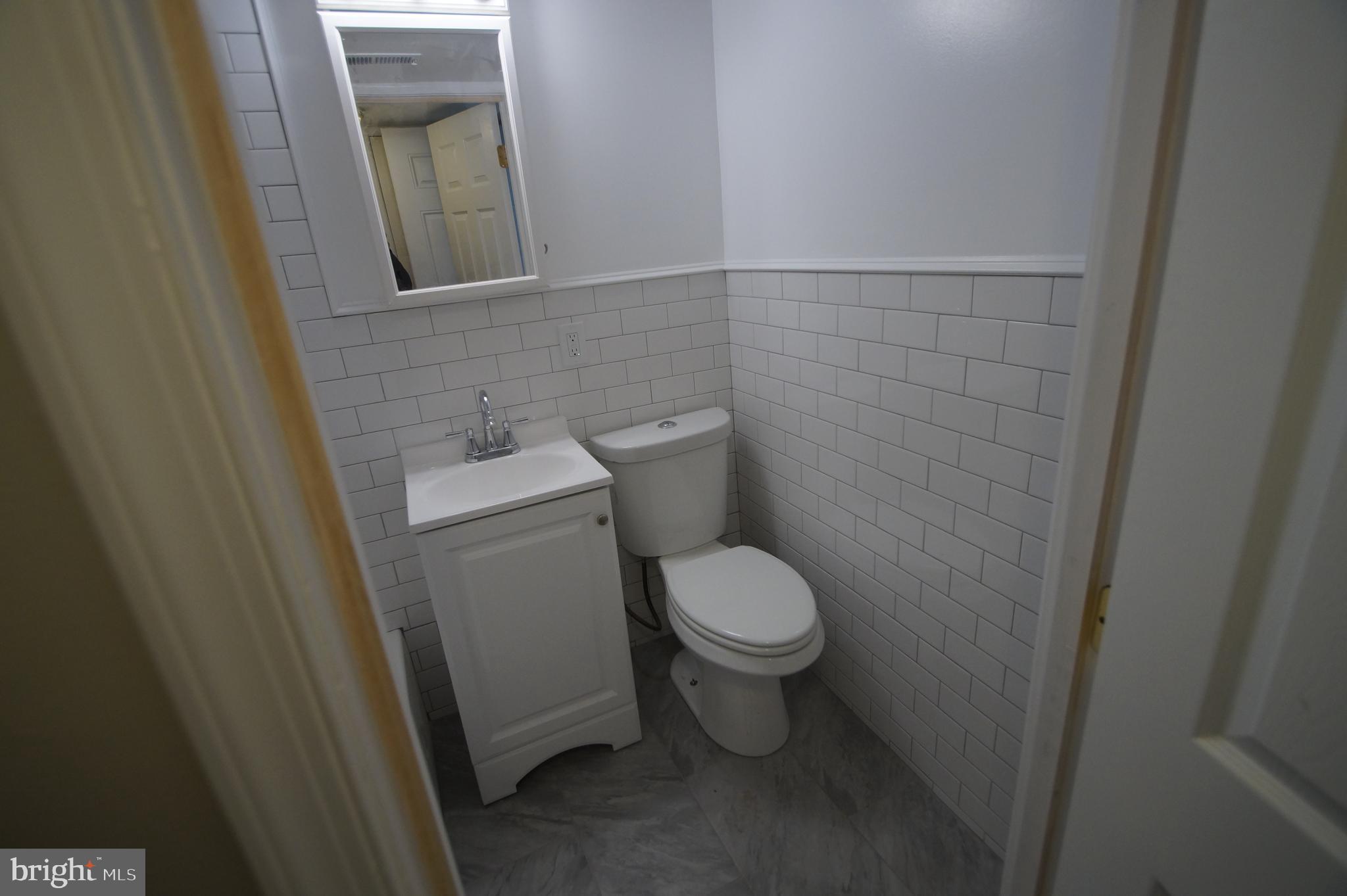 1004 Christian Street Philadelphia, PA 19147 - Photo 28 of 34 a white toilet sitting next to a sink