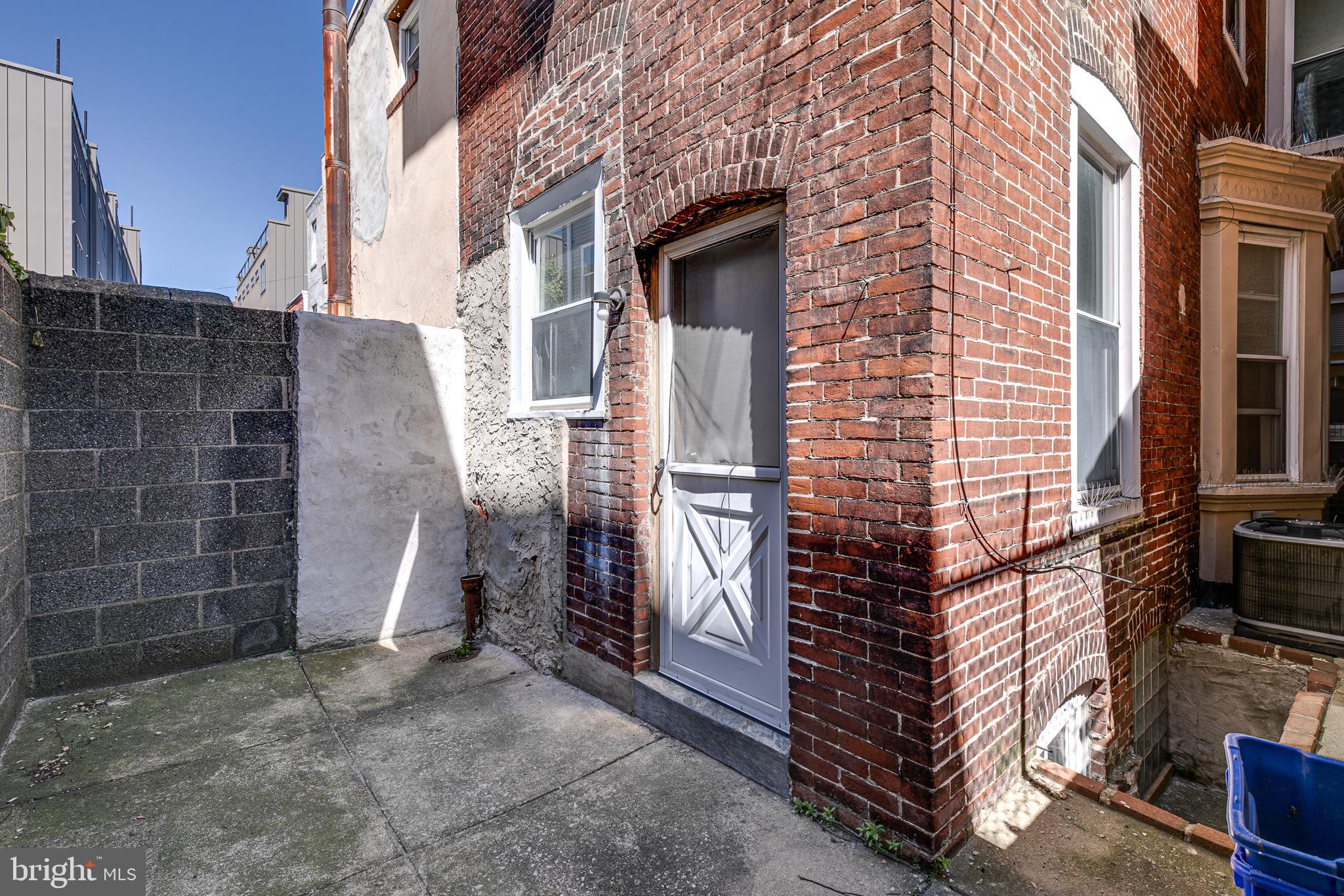 1004 Christian Street Philadelphia, PA 19147 - Photo 33 of 34 a view of a house with a door and wooden walls