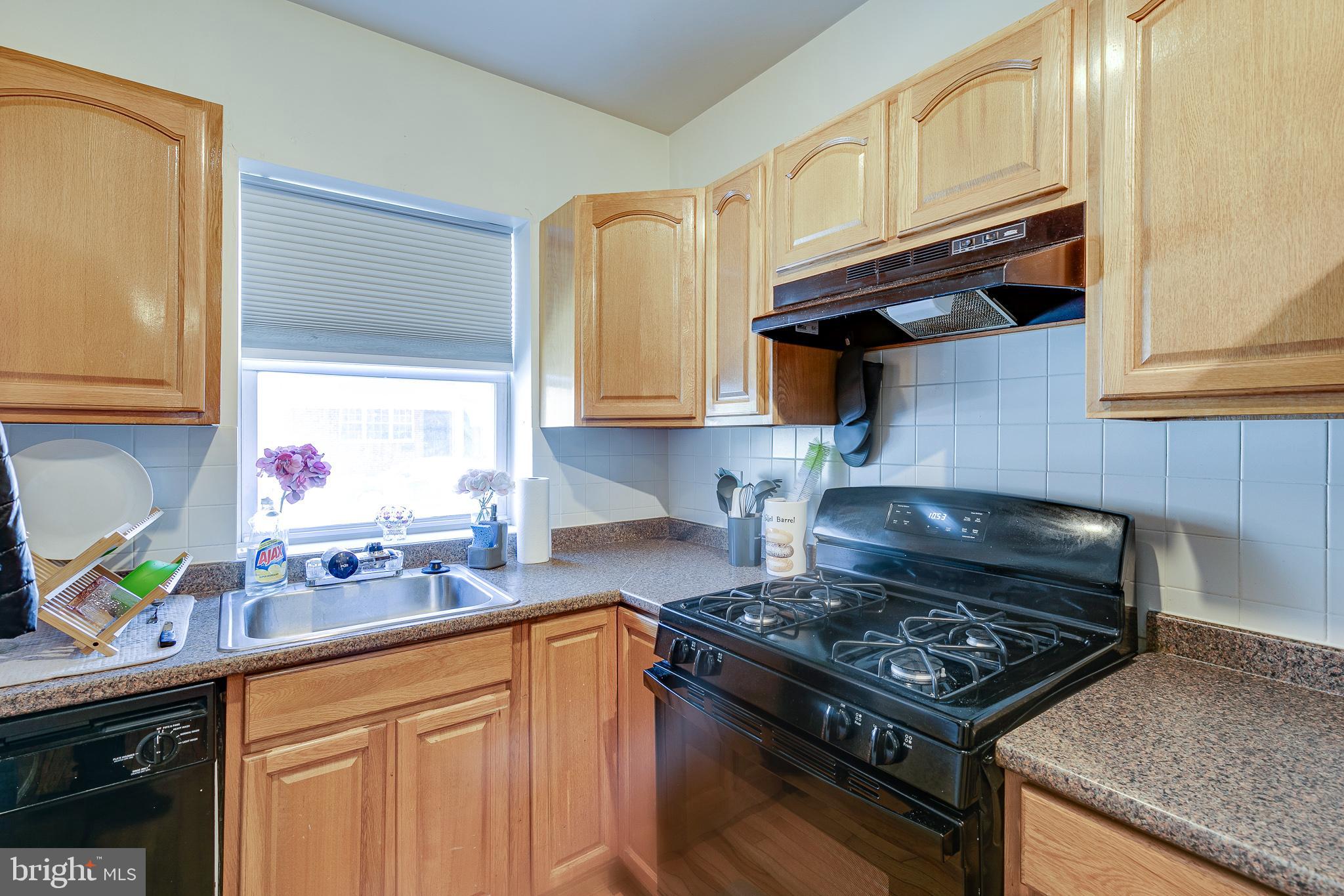 1004 Christian Street Philadelphia, PA 19147 - Photo 6 of 34 a kitchen with stainless steel appliances granite countertop a stove a sink and a microwave