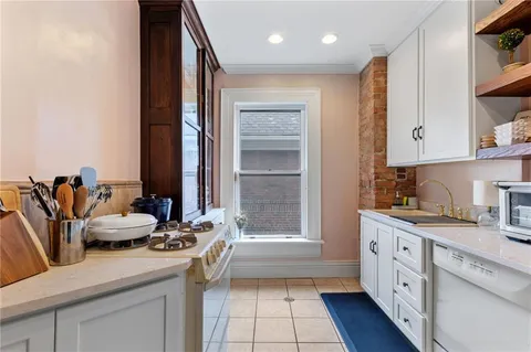 a kitchen with a sink stove and cabinets