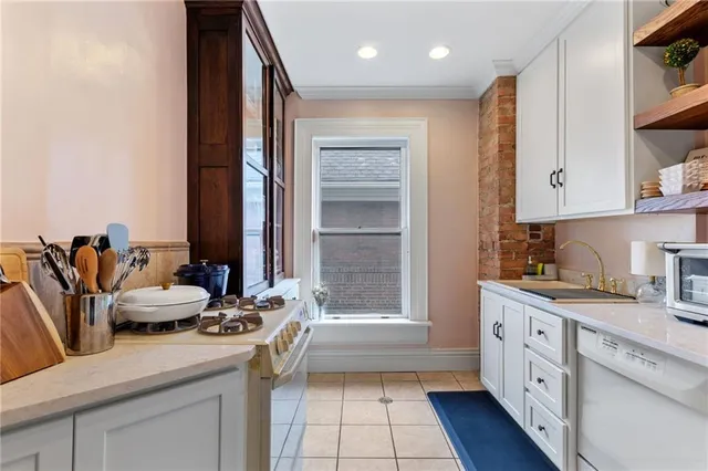 a kitchen with a sink stove and cabinets