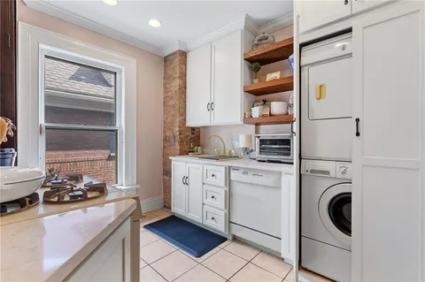 a kitchen with white cabinets and white appliances