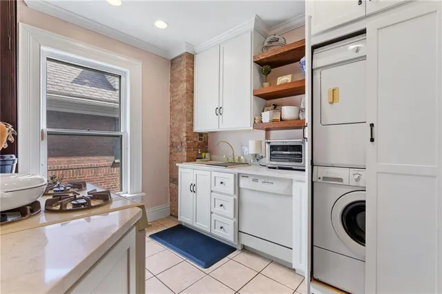 a kitchen with white cabinets and white appliances