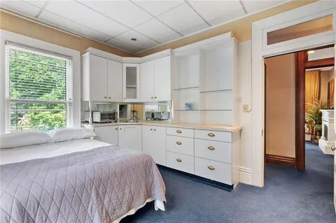 a spacious bedroom with a large bed and a window