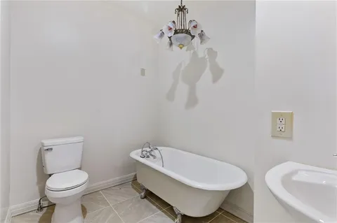 a white toilet sitting next to a bathroom sink