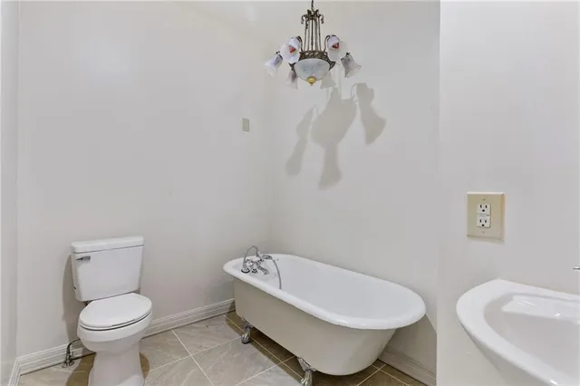 a white toilet sitting next to a bathroom sink