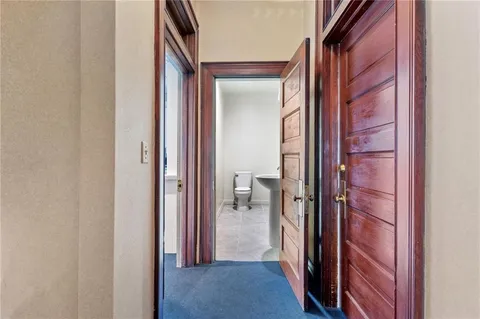 a view of a bathroom from a corridor
