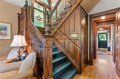 a view of entryway and hall with wooden floor