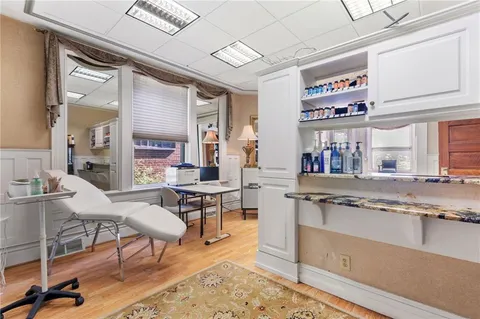 a view of kitchen with furniture and wooden floor