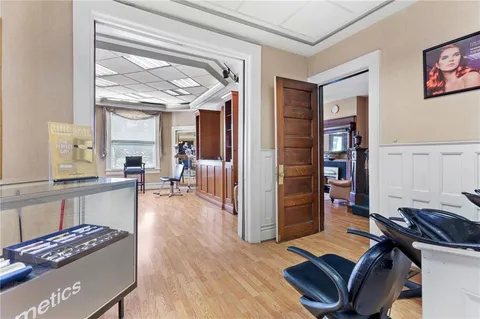 a kitchen with stainless steel appliances wooden cabinet and a fireplace
