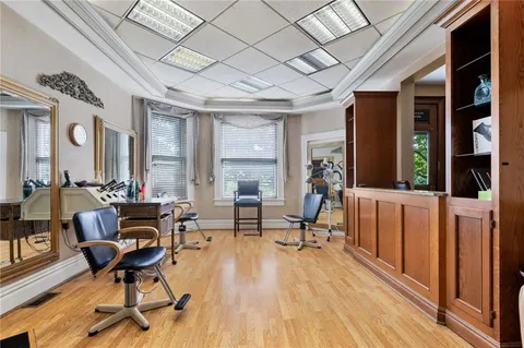 a view of a livingroom with furniture a fireplace and wooden floor