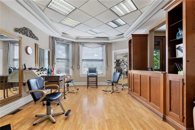 a view of a livingroom with furniture a fireplace and wooden floor