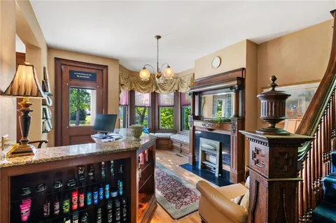 a spacious bathroom with a large window and a chandelier
