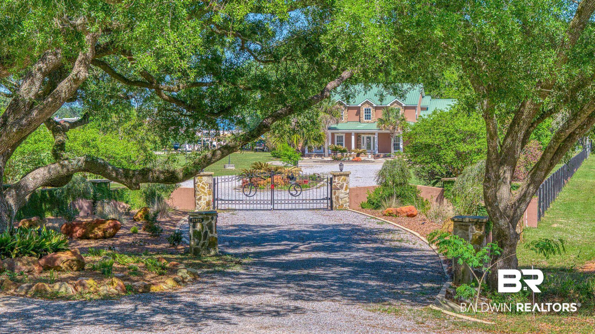 32875 Faircloth Road Lillian, AL 36549 - Photo 1 of 85 View of property's community with driveway and a gate