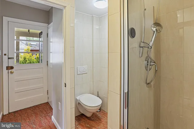 a bathroom with a toilet and a shower