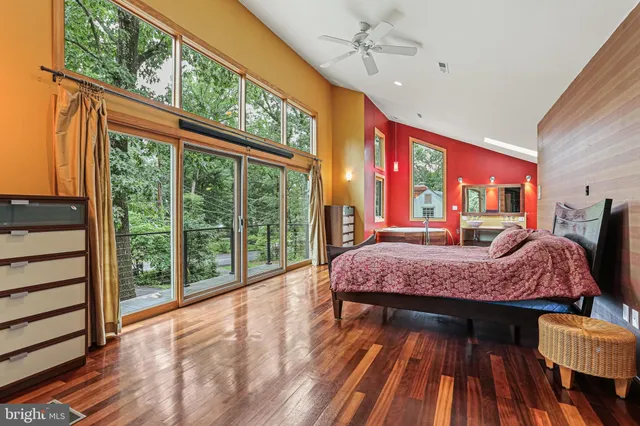 a living room with furniture a bed and wooden floor