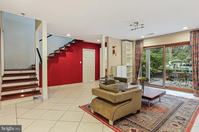a living room with furniture and a floor to ceiling window