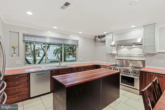 a kitchen with a stove a sink and a refrigerator