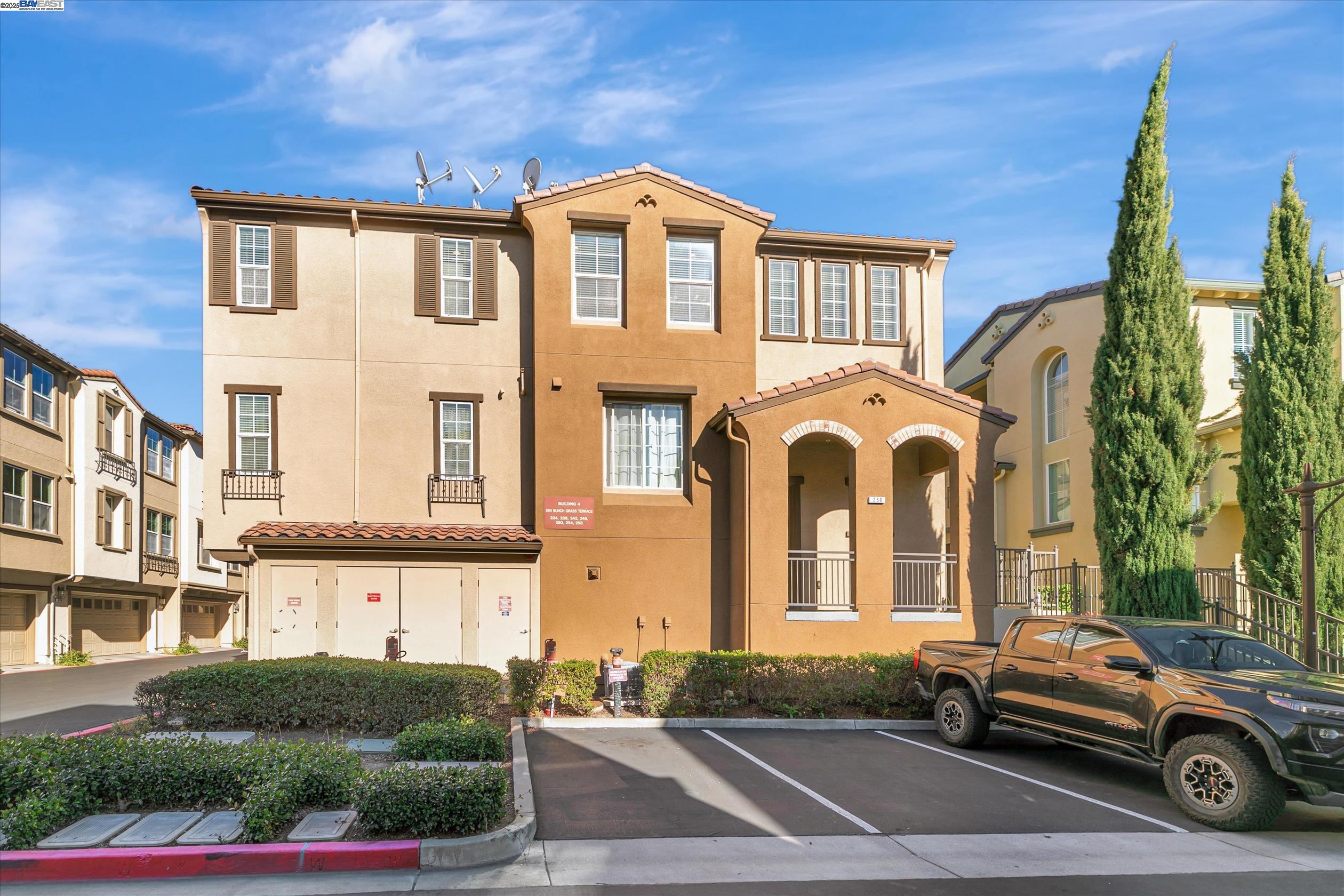 a front view of a residential apartment building with a yard