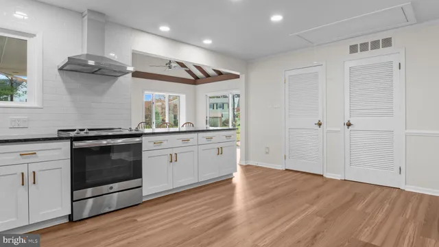 a kitchen with stainless steel appliances granite countertop a stove and a sink