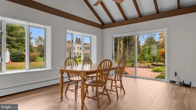 a dining room with furniture window outside view and wooden floor