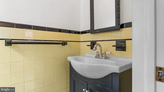 a view of an empty room with wooden floor and windows